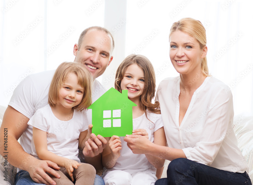 smiling parents and two little girls at new home smiling parents and two little girls at new home