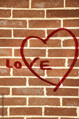 Graffiti heart on brick wall