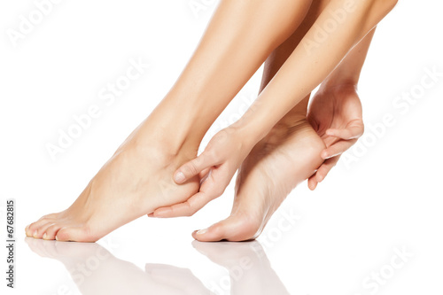 woman tenderly touching her feet
