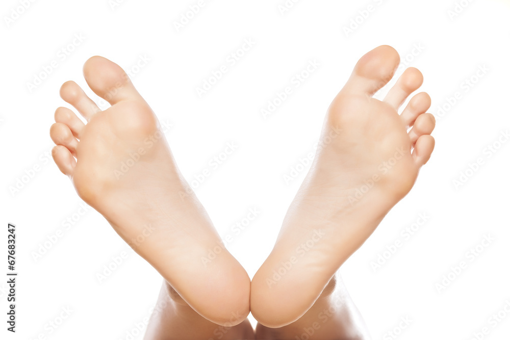 spread female feet on white background spread female feet on white background