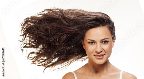 Pretty girl with long blowing wavy hair