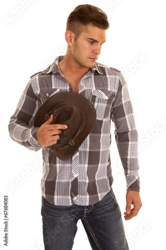 man plaid shirt western hat in hand look down