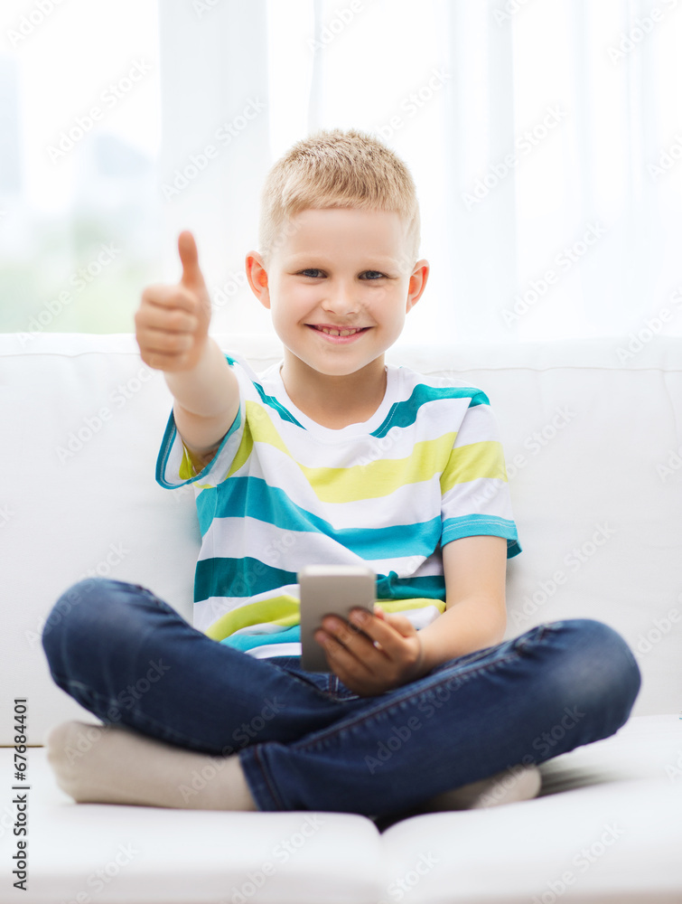 smiling boy with smartphone showing thumbs up smiling boy with smartphone showing thumbs up