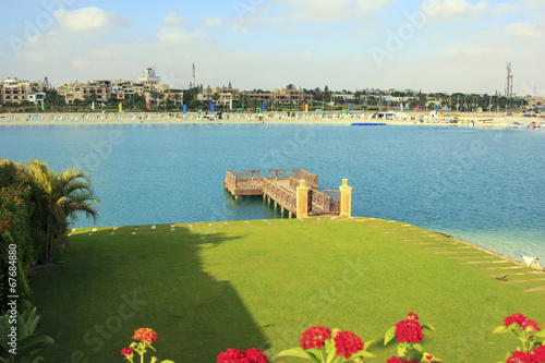 Wooden dock in front of lake beach in sunny day 
 photo