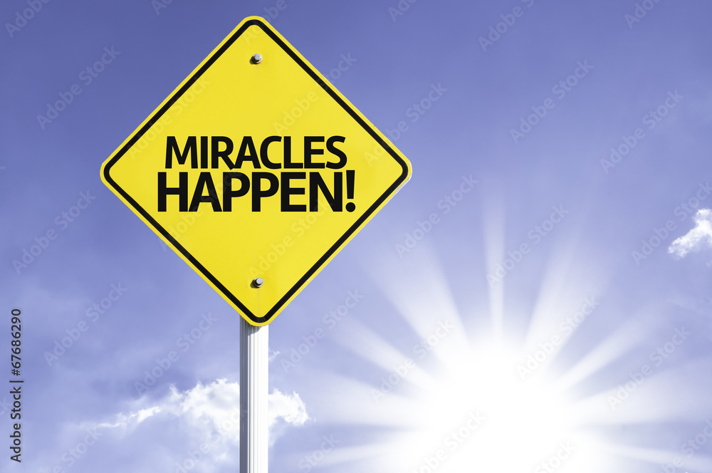 Miracles Happen road sign with sun background Miracles Happen road sign with sun background