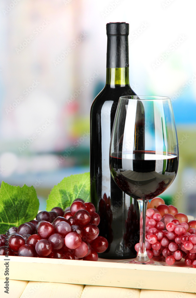 Ripe grapes, bottle and glass of wine