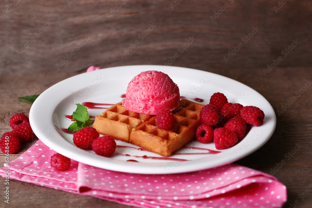 Tasty belgian waffles with ice cream on wooden table Tasty belgian waffles with ice cream on wooden table