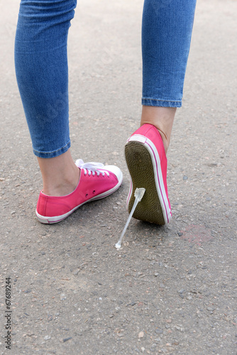 Foot stuck into chewing gum on street