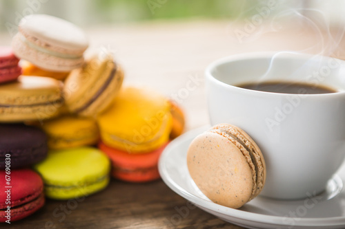 French colorful macarons with cup of coffee