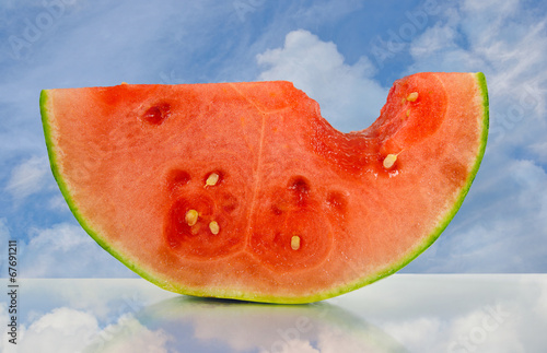 juicy watermelon with sky reflection