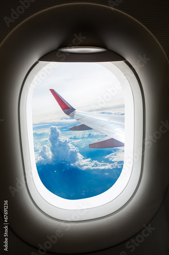 Plane window with cloud view