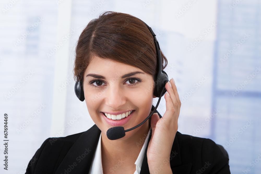 Confident Businesswoman Wearing Headset In Office Confident Businesswoman Wearing Headset In Office