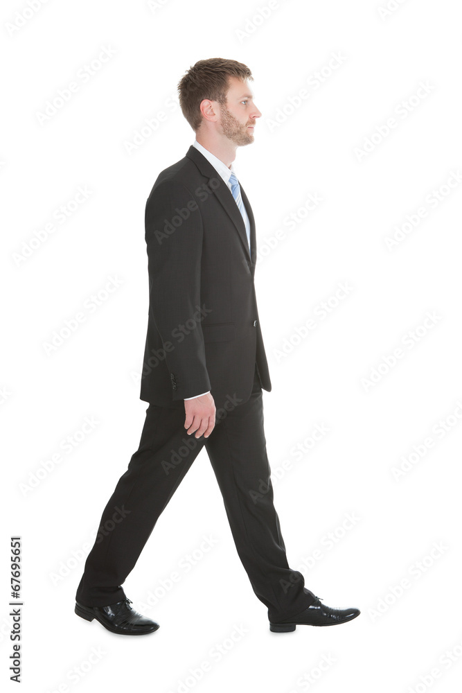 Confident Businessman Walking Over White Background Confident Businessman Walking Over White Background