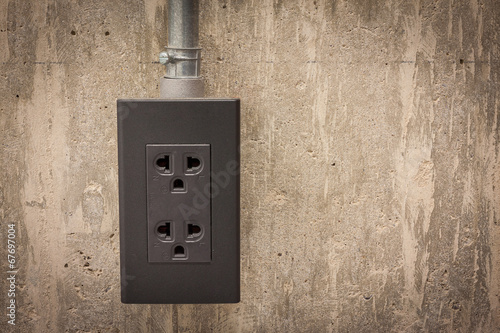 Electric plug on cement wall © hadkhanong
