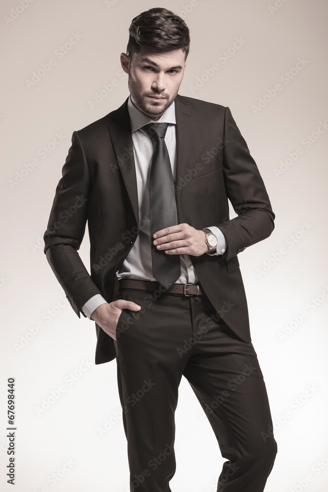 Fototapeta premium sexy young business man holding his tie
