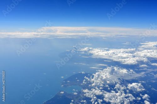 Earth's surface with sea and clouds