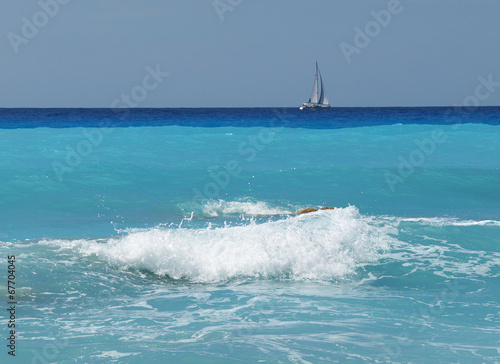 sea ​​waves and sailing boat in the background