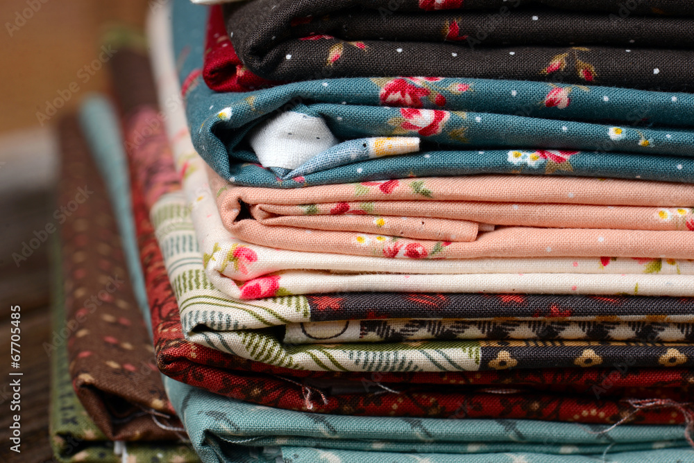 heap of cloth fabrics on wooden table heap of cloth fabrics on wooden table