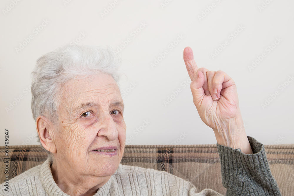 senior person pointing something with her finger senior person pointing something with her finger