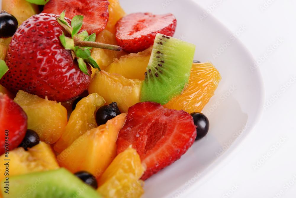 Fresh fruits salad on plate close up Fresh fruits salad on plate close up