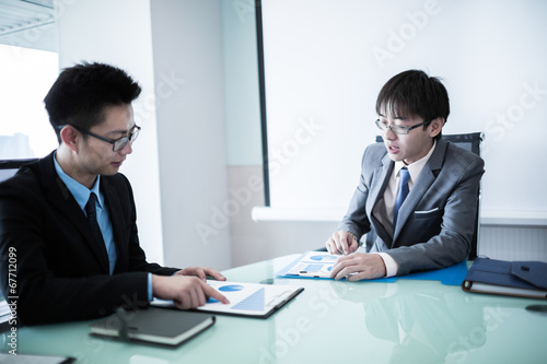 Wallpaper Mural Young business people sitting in board room during meeting and d Torontodigital.ca