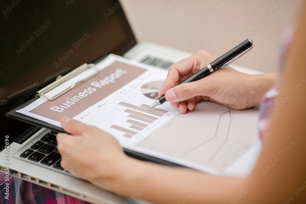 Young business woman planing, writing and reviewing report at ci Young business woman planing, writing and reviewing report at ci