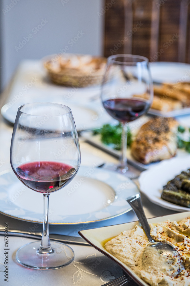 wine glasses and food on dinner table