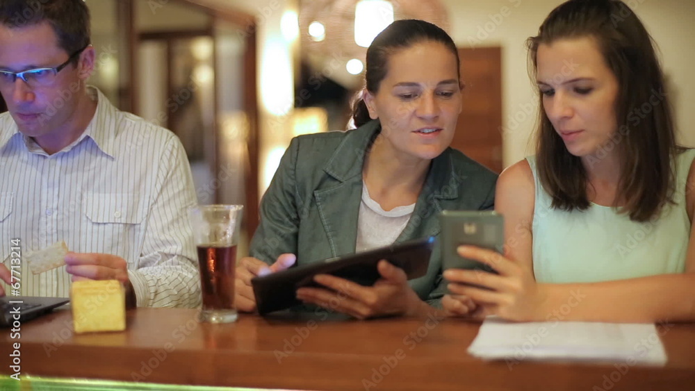 People working on modern technology in pub, steadycam shot People working on modern technology in pub, steadycam shot