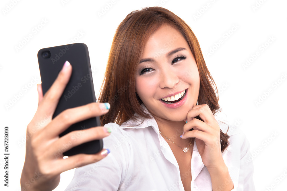 Pretty girl take a self portrait with her smart phone. Pretty girl take a self portrait with her smart phone.