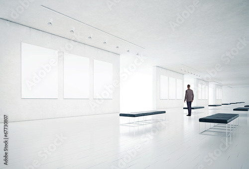 gallery room and man looking at empty frames