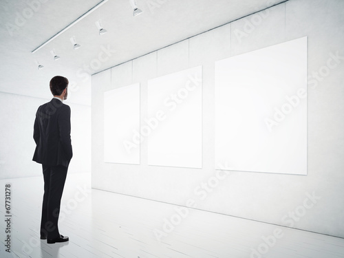 gallery room and man looking at empty frames