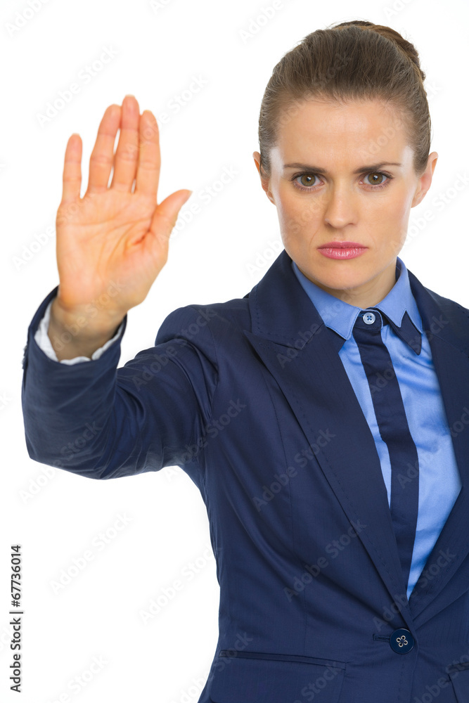 Serious business woman showing stop gesture Serious business woman showing stop gesture