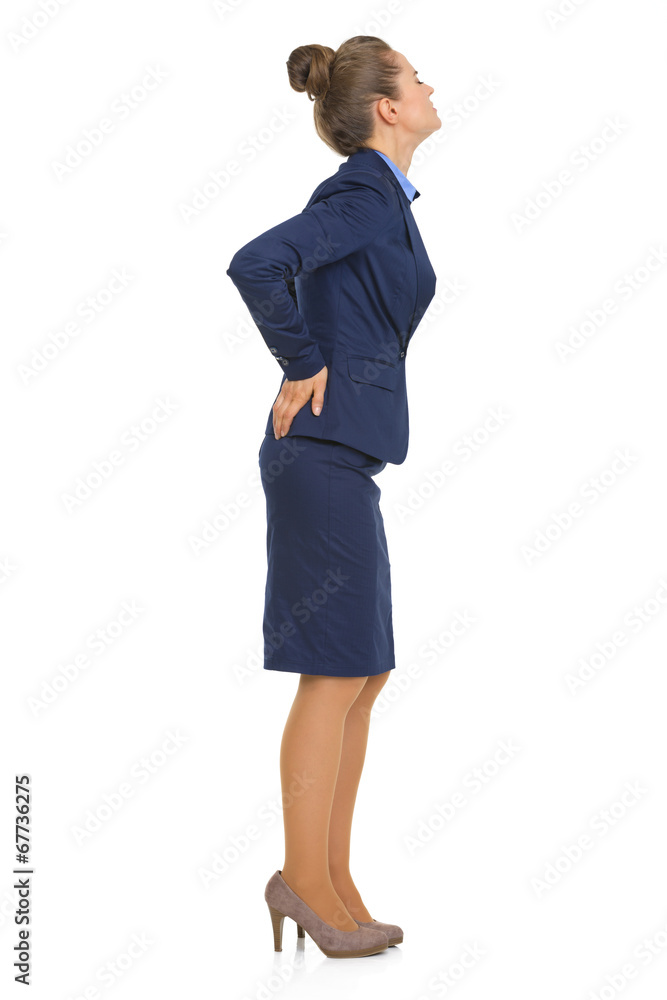 Full length portrait of business woman with back pain Full length portrait of business woman with back pain