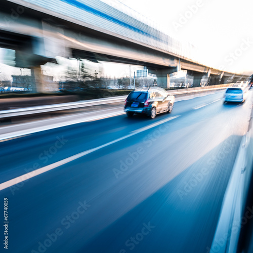 Car driving on freeway at sunset, motion blur