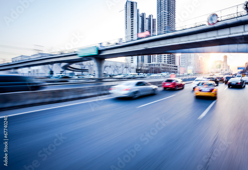 Car driving on freeway at sunset, motion blur