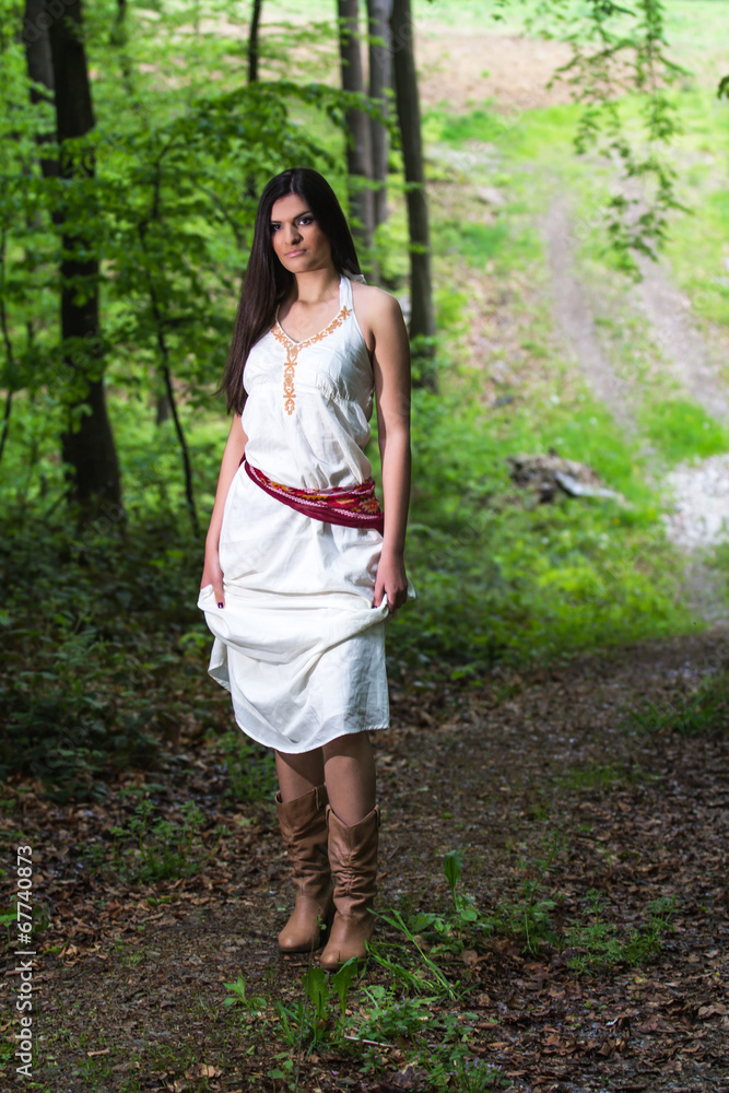Young woman in a forest enjoying Young woman in a forest enjoying