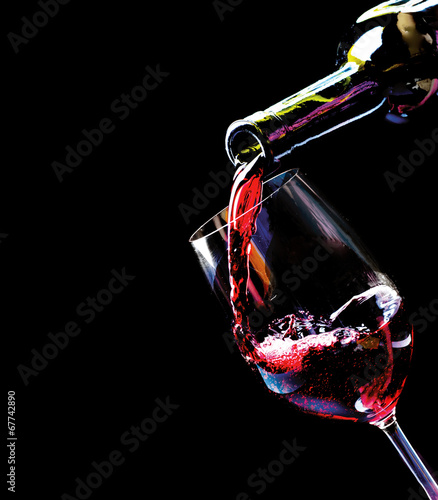 Wine. Red wine pouring into a wine glass