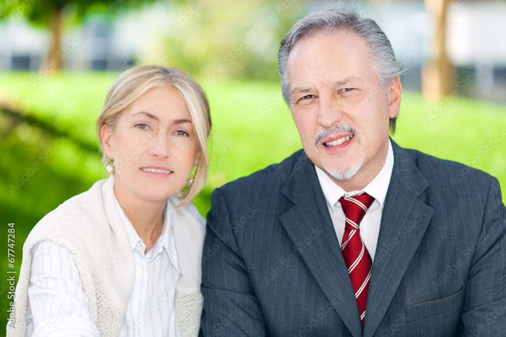 Two business people smiling in an urban setting Two business people smiling in an urban setting