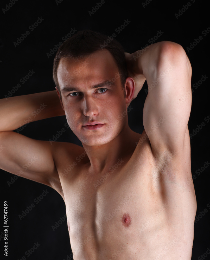 Portrait of a naked muscular man, isolated on black Portrait of a naked muscular man, isolated on black