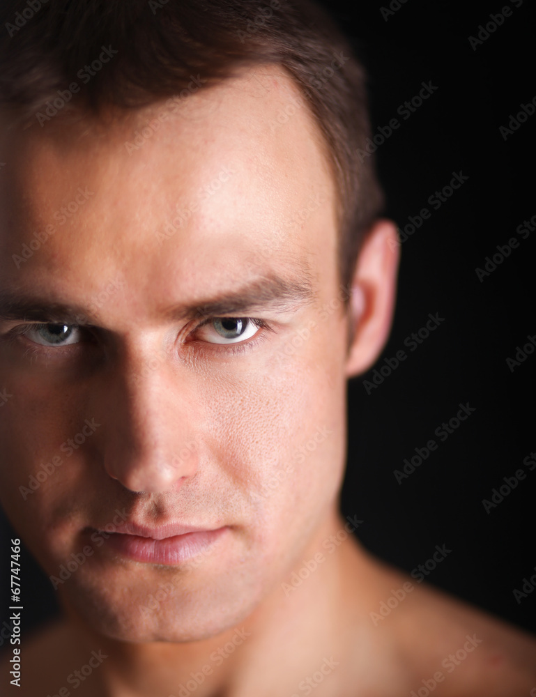 Portrait of a naked muscular man, isolated on black Portrait of a naked muscular man, isolated on black