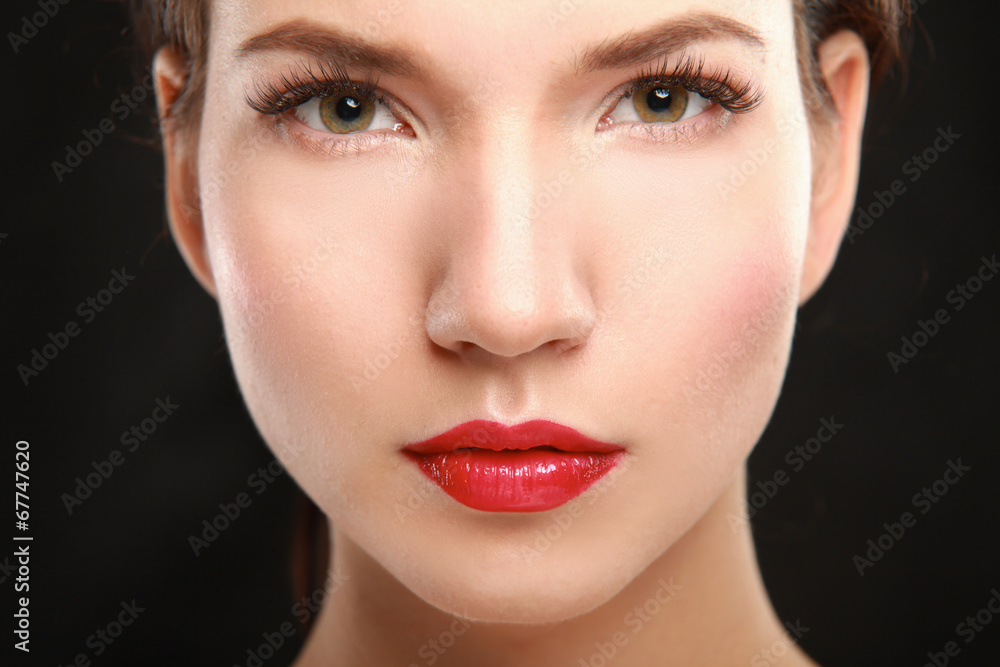 Young woman touching her face Young woman touching her face