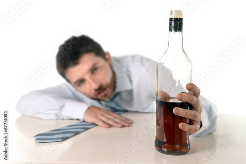 drunk businessman drinking whiskey at office