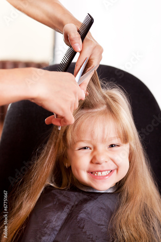 Happy little girl at the hairdresser