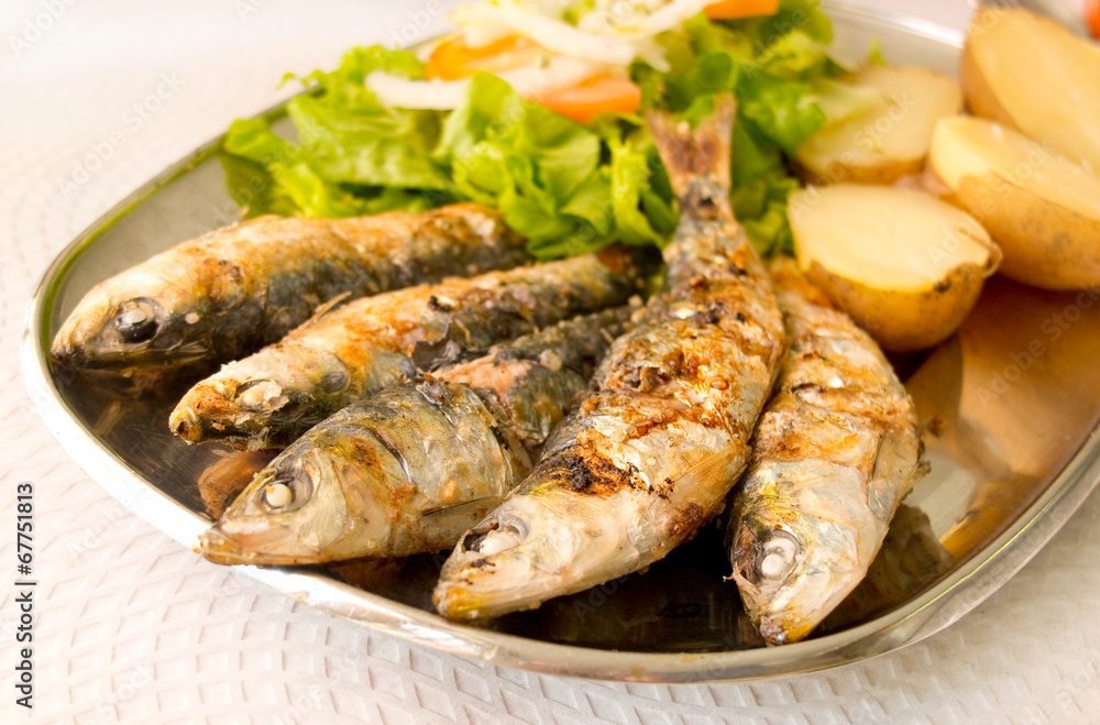 Grilled sardines with mediterranean salad and boiled potatoes. Grilled sardines with mediterranean salad and boiled potatoes.