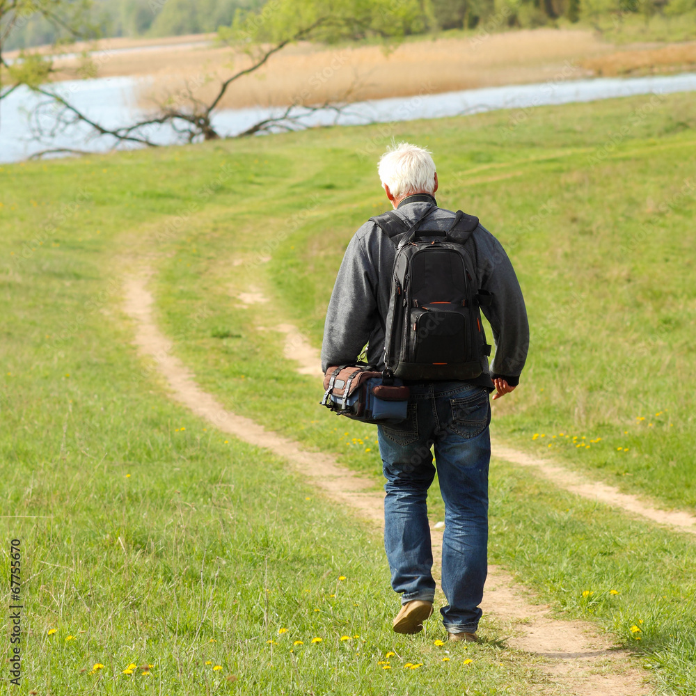 Old  man photographer photographing in nature