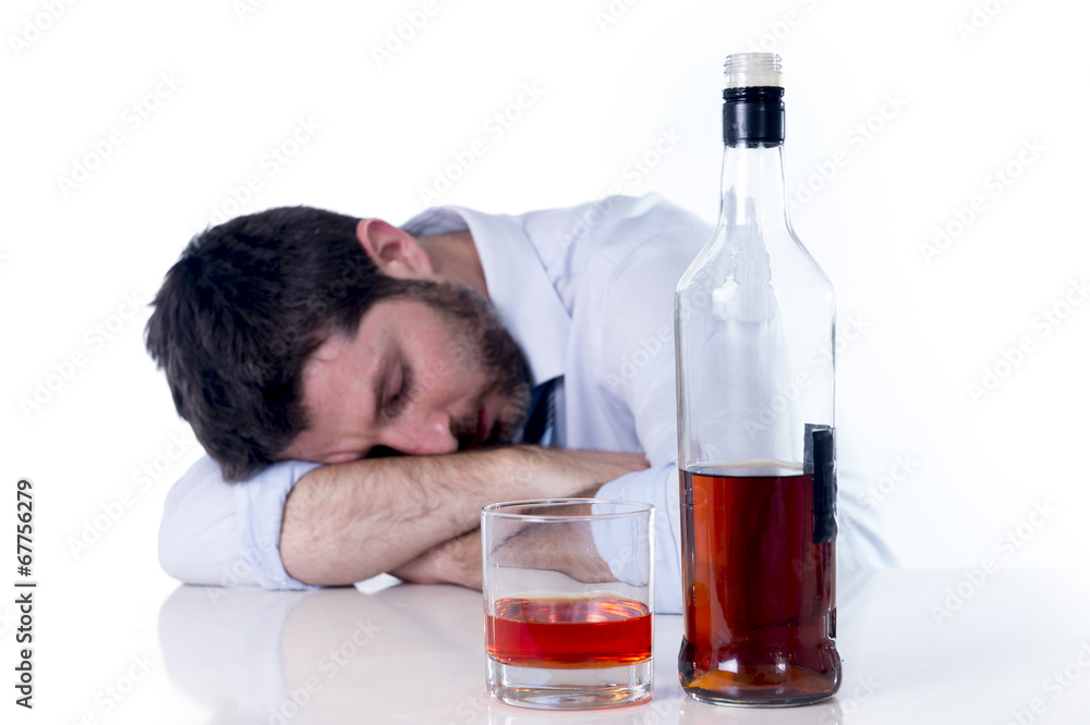 alcoholic Business man asleep drunk at desk with hangover alcoholic Business man asleep drunk at desk with hangover