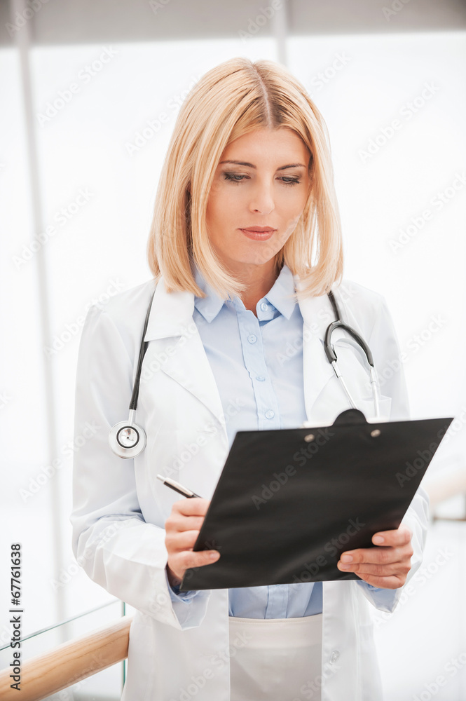 Fototapeta premium Doctor making notes.