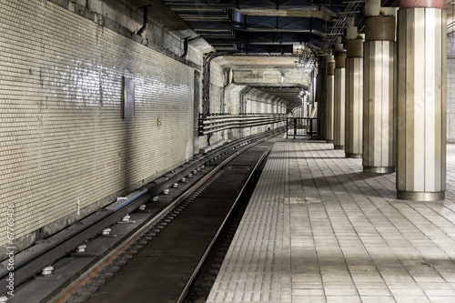 Old subway track in tunnel for train.