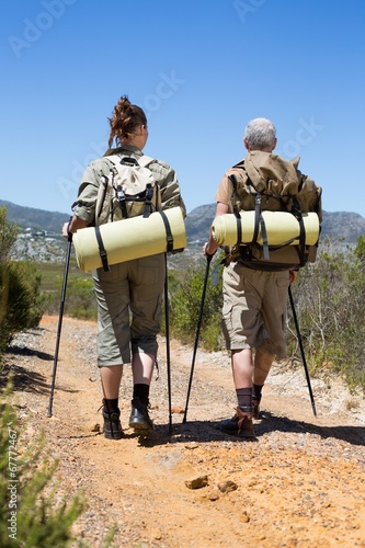 Hiking couple walking on mountain trail