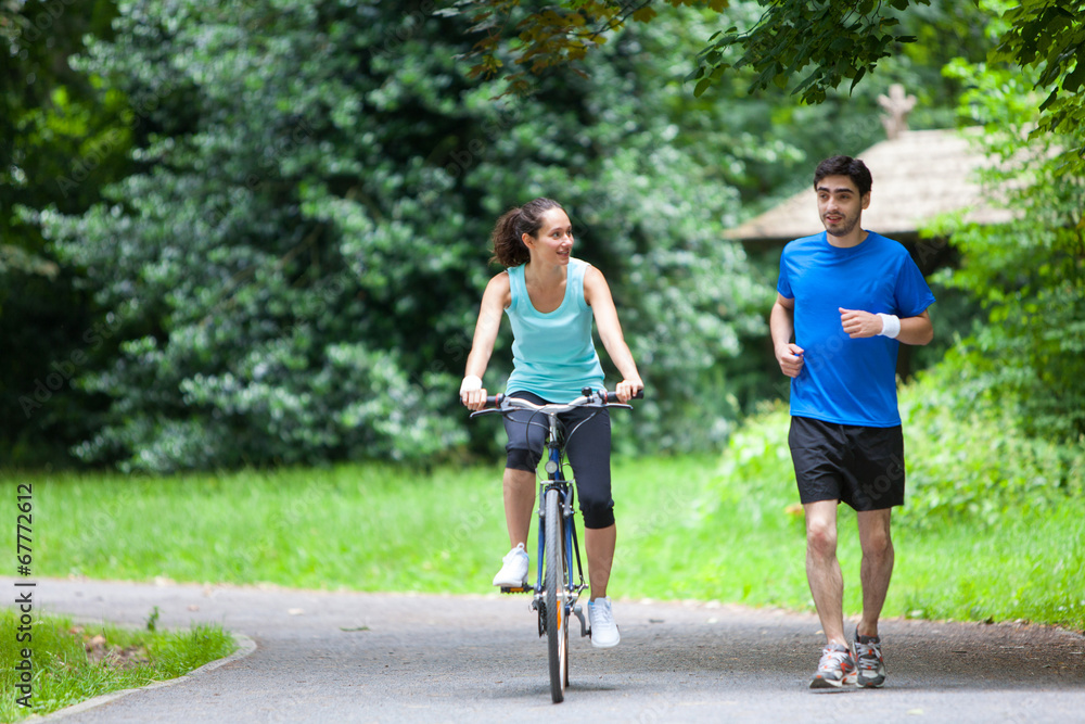 Young sportive couple jogging at the park Young sportive couple jogging at the park